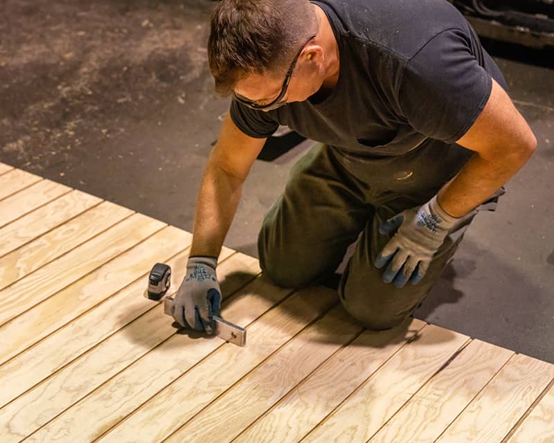 A worker inspects siding for quality control