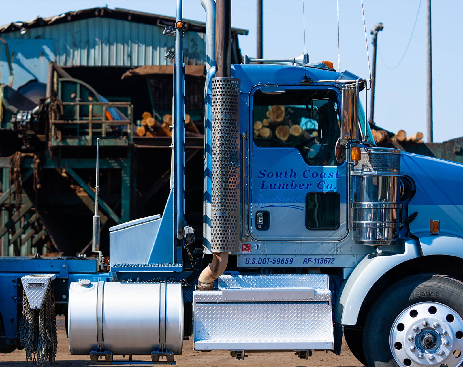 A photo of a South Coast Lumber company semi truck in front of the plant